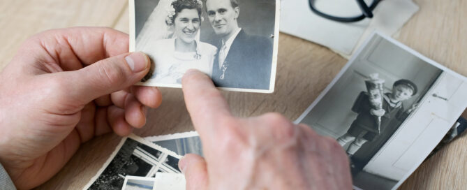 An elderly man looks through his old photographs of 1960-1965